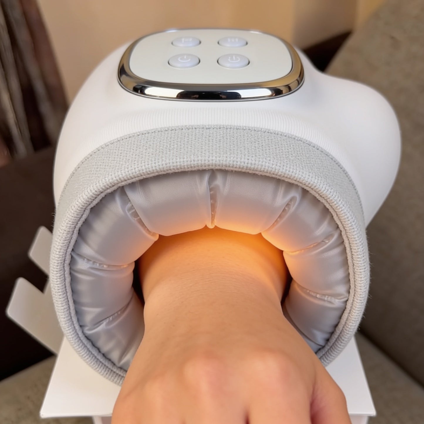 POV inside the hand massager showing air-compression cushions and warming heat
